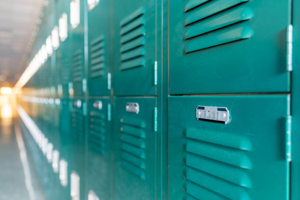 istock Green metal lockers along a nondescript hallway in a typical US High School.  No identifiable information included and nobody in the hall. 1420229120