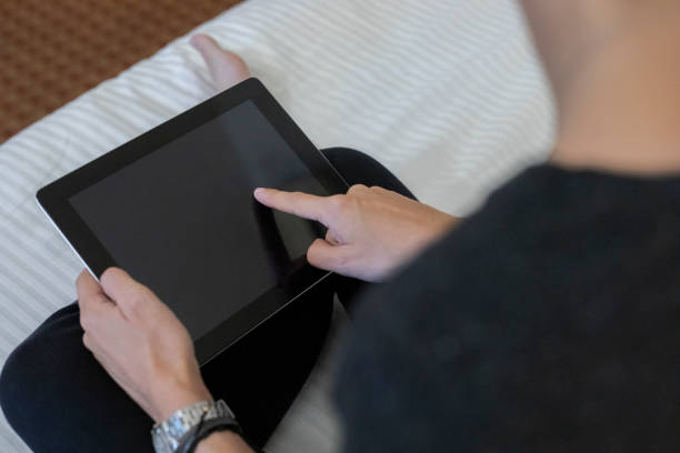 woman using the tablet in hotel room