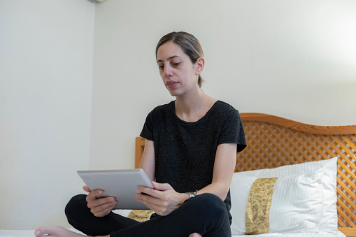 woman using the tablet in hotel room