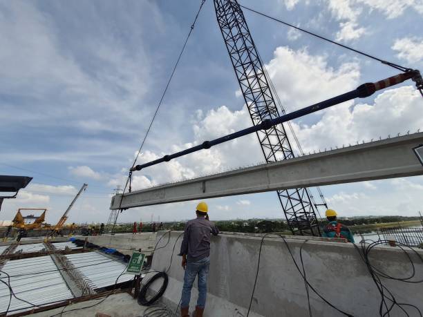A supervisory consultant is supervising the erection girder work using a single crane. stock photo