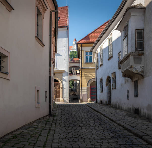 Old Town alley street with Bratislava Castle on background - Bratislava, Slovakia Old Town alley street with Bratislava Castle on background - Bratislava, Slovakia bratislava castle bratislava castle fort stock pictures, royalty-free photos & images