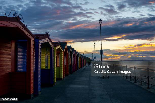 Multi Coloured Sea Huts Light By A Summer Sunset Stock Photo - Download Image Now - Tourism, Architecture, Beach