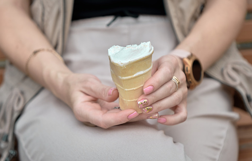 Women's hands holding ice cream in waffle cup. in Zaporizhzhia, Zaporizhia Oblast, Ukraine