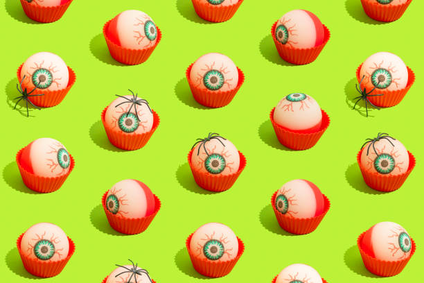 istock Trendy Halloween pattern with bloody eyes in baking cup. Seamless pattern. Vibrant bright green background. 1420244344