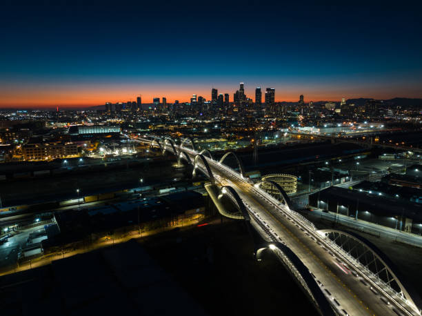 Evening Drone Shot of Sixth Street Bridge and Downtown Los Angeles Aerial view of the new Sixth Street Viaduct connecting  the Downtown Los Angeles Arts District to Boyle Heights across the Los Angeles River at nightfall. sixth street bridge stock pictures, royalty-free photos & images