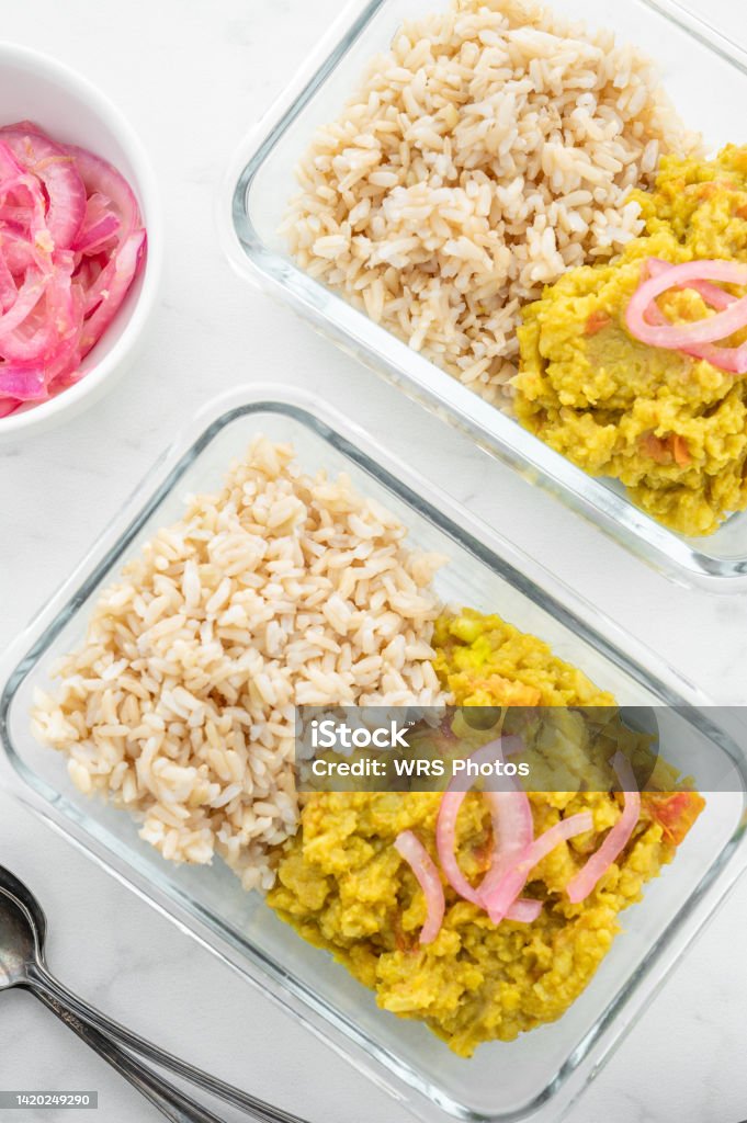 Split Pea Dal and Brown Rice in "To Go" Glass Containers Split pea dal and brown rice leftovers with pickled onion in "to go" glass storage containers for quick and easy lunch or dinner Box - Container Stock Photo