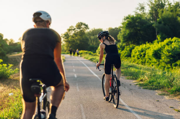 istock Couple riding road bicycles outside and wearing helmets and sunglasses 1420249305