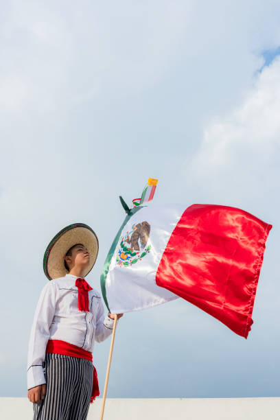 istock Young boy holding flag of Mexico 1420260749