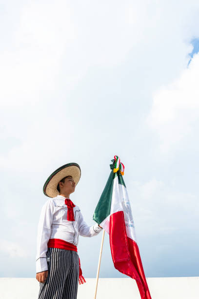 istock Young boy holding flag of Mexico 1420261422