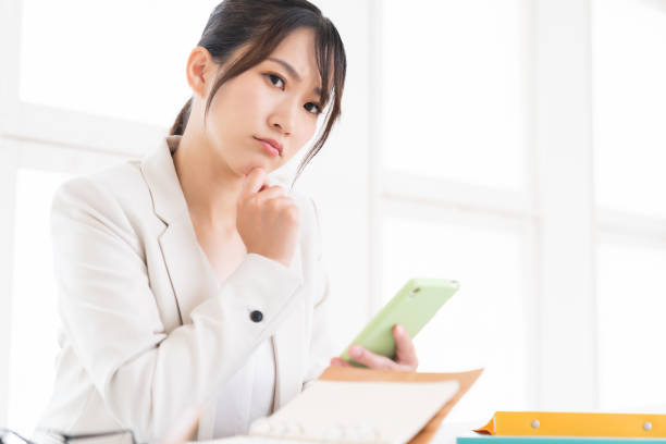 istock young asian woman who see a smart phone,think, 1420266188