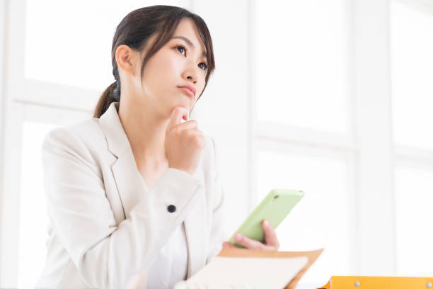 istock young asian woman who see a smart phone,think, 1420266225