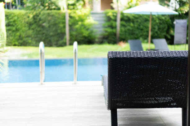 istock Swimming pool with stair and Black chairs. 1420269420