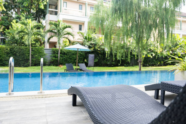 istock Swimming pool with stair and Black chairs. 1420269444