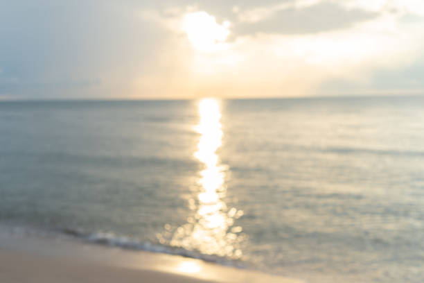 istock blur morning sunrise at white beach sea, background. 1420272155