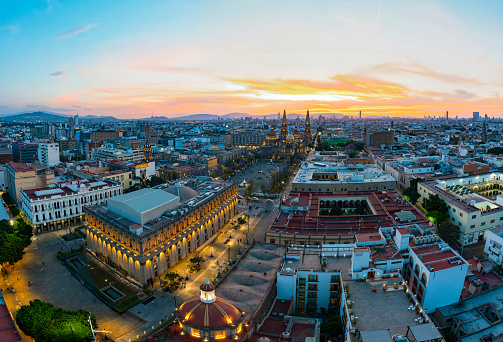 Guadalajara, Mexico - March 15, 2020: aerial footage in the center of the city of Jalisco with huge classic buildings and old churches such as the Parroquia El Sagrario Metropolitano and the Degollado Theater on a beautiful morning