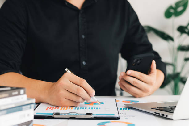 istock businessman working in the office with documents on their desks Planning to analyze financial reports business plan investment financial analysis concept. 1420284461