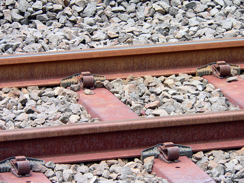 Railway train tracks surrounded by gravel stones