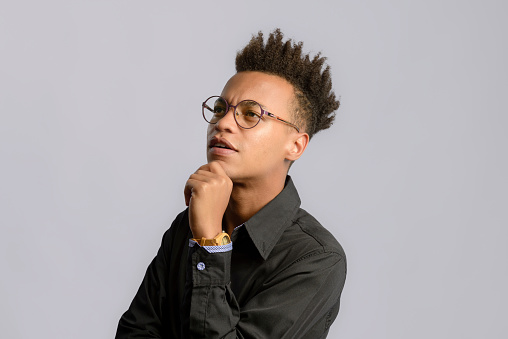 Young black man in studio with gray background