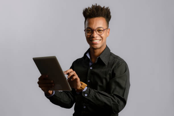istock Portrait of young adult man using digital tablet 1420295295