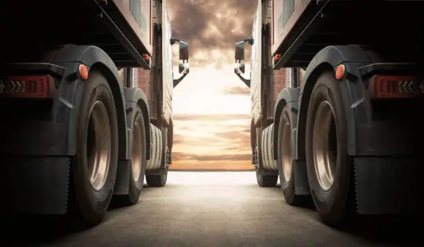 Photo of Semi TrailerTrucks on Parking with The Sunset Sky. Shipping Container Truck. Delivery Transit. Engine Diesel Truck Tractor. Industry Freight Trucks Logistics Cargo Transport.