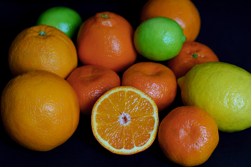 Orange, lemon. lime and leaves on a white background.