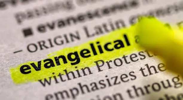 Close up photo of the word evangelical in a dictionary book