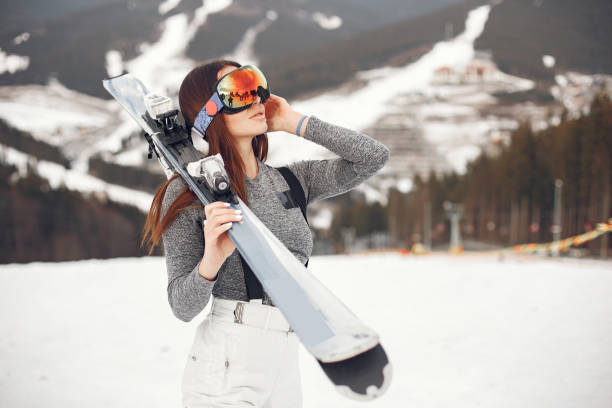 Woman skier in a winter day at a ski resort stock photo