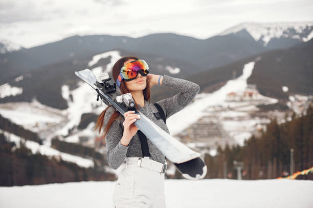 Woman skier in a winter day at a ski resort stock photo