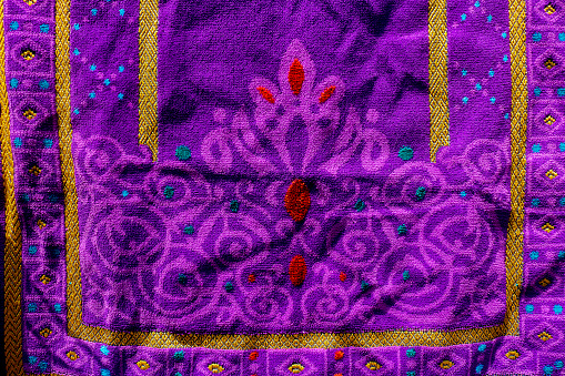 The purple carpet prayer rug is drying. Beautiful carpet motif that was held