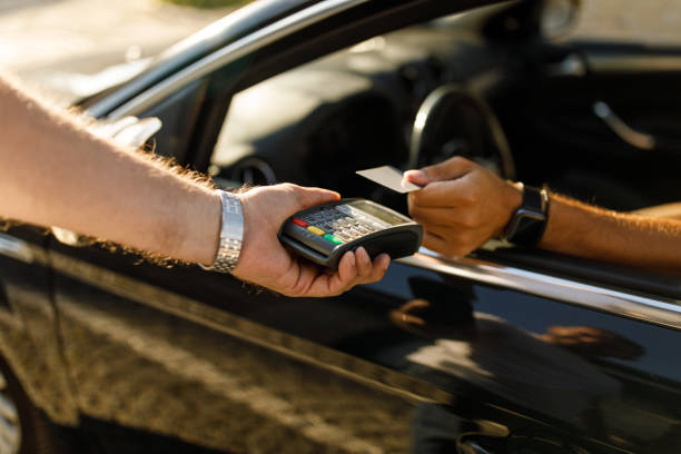 istock Man using a credit card and paying at the curbside pickup 1420304739