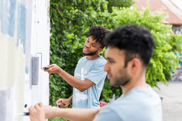 istock Brothers work together to paint 1420307916