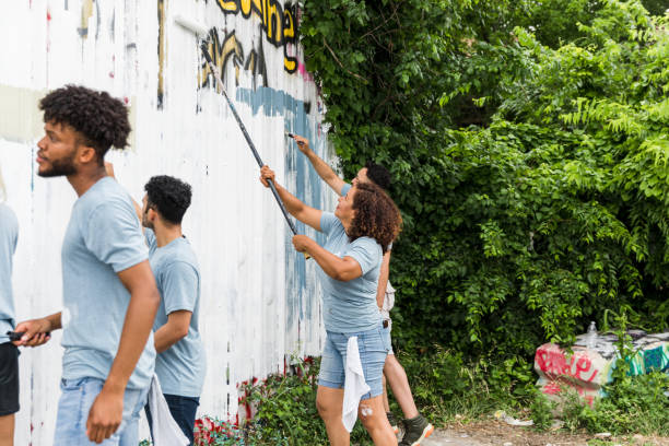 istock Multiracial family works together to paint the graffiti wall 1420307921
