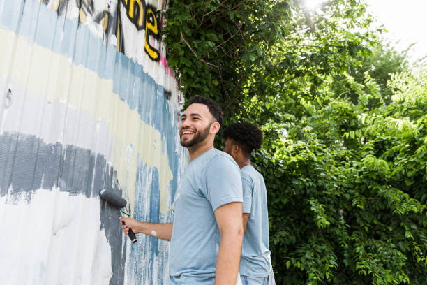 istock Friends work together on the mural 1420307938
