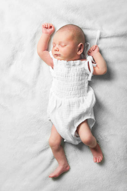 istock Little baby sleeping close-up on crib 1420308144