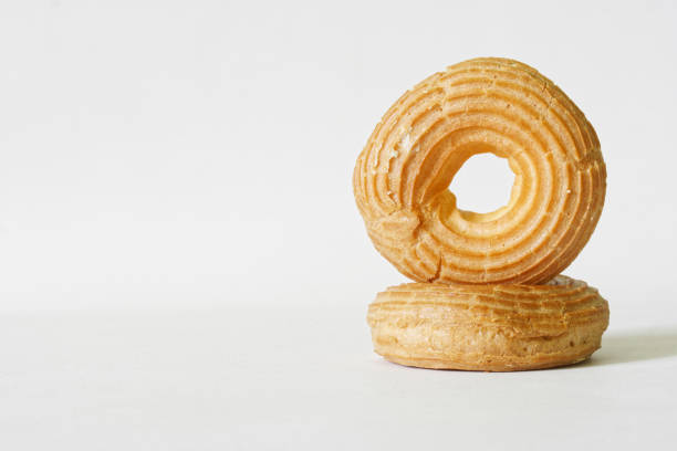 istock Two freshly baked round donuts without icing on a light background - a shop or bakery showcase. Close-up. Copy space 1420308560