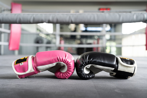 pink and black Boxing glove in punching in woman concept.