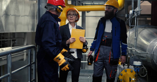 istock Working in a power plant is not easy! Workers talk to the supervisor about how to work at the power plant. 1420315499
