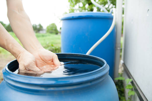 istock hand touching rainwater in barrel 1420317440