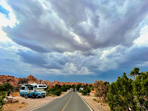 Moab, Utah, USA - July 14, 2021: A dynamic cloudscape from an impending late afternoon storm blankets the sky over a campground within Arches National Park.