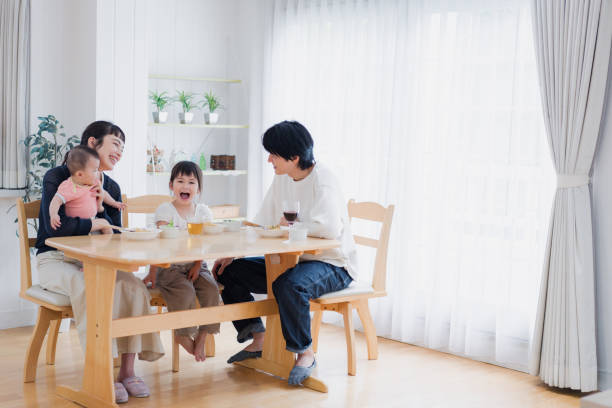 A happy family eating dinner together stock photo