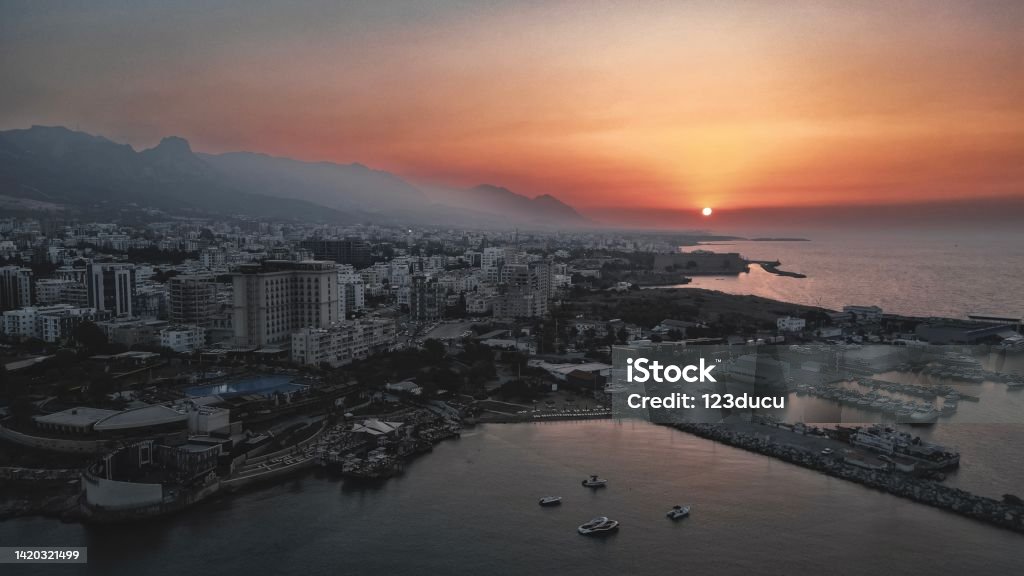 Beautiful Sunset at north cyprus kyreina aerial view stock photo Kyrenia (Girne) is a city on the north coast of Cyprus, known for its cobblestoned old town and horseshoe-shaped harbor. Aerial View Stock Photo