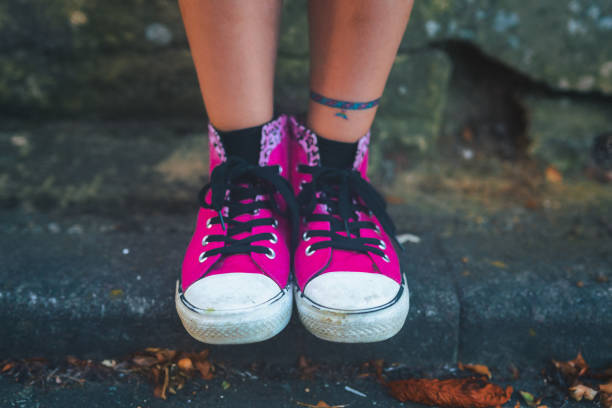 Closeup shot of a girl in stylish pink sneakers stock photo