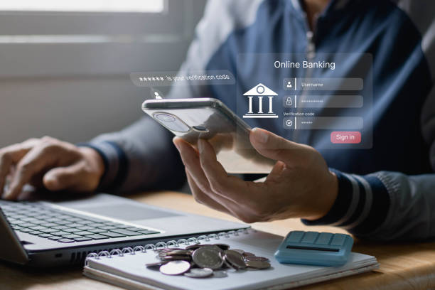 istock cyber security and two-step verification concept. Online Payment Internet Banking Concept. Man's hands are holding mobile smartphone making Online shopping and payment with a laptop computer. 1420322207