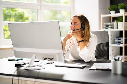 Confident young business woman wearing headset