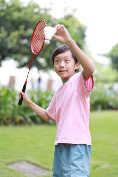 istock Boy playing badminton in public park 1420326928
