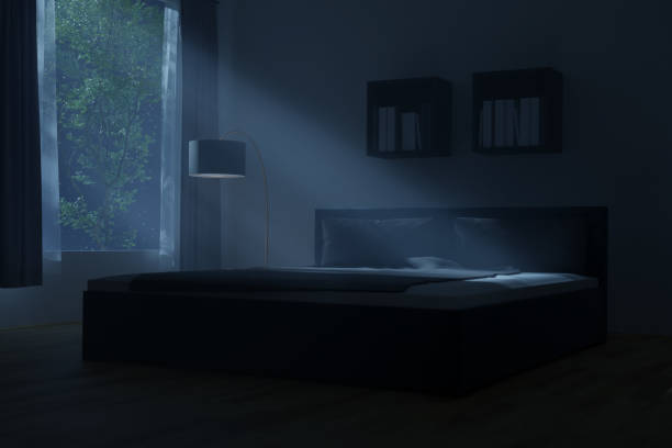 istock 3D rendering of spacious bedroom with cozy box-spring bed illuminated by light rays at night 1420333323