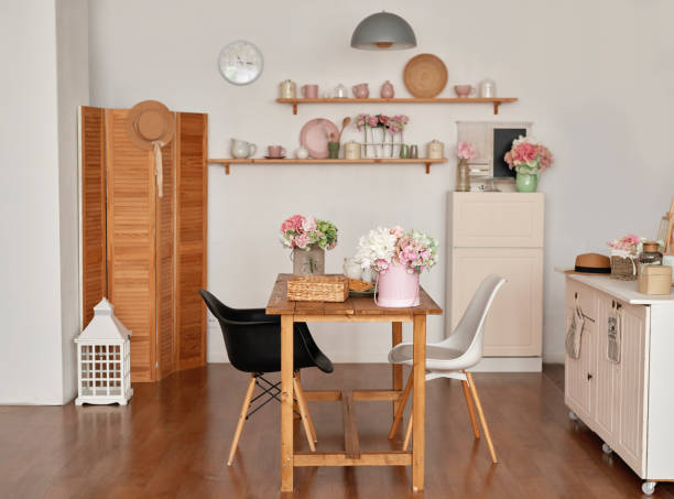istock White kitchen interior in loft style. Shelves with pink crockery and kitchen utensils. Studio apartment. Rent and delivery of housing. Hostel and hotel 1420347362