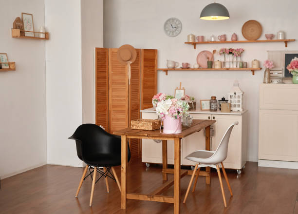 istock White kitchen interior in loft style. Shelves with pink crockery and kitchen utensils. Studio apartment. Rent and delivery of housing. Hostel and hotel 1420347382