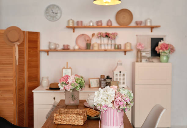 istock White kitchen interior in loft style. Shelves with pink crockery and kitchen utensils. Studio apartment. Rent and delivery of housing. Hostel and hotel 1420347485