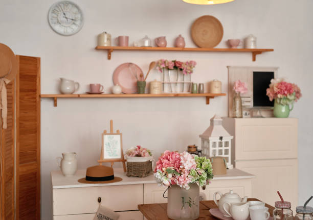 istock White kitchen interior in loft style. Shelves with pink crockery and kitchen utensils. Studio apartment. Rent and delivery of housing. Hostel and hotel 1420347726